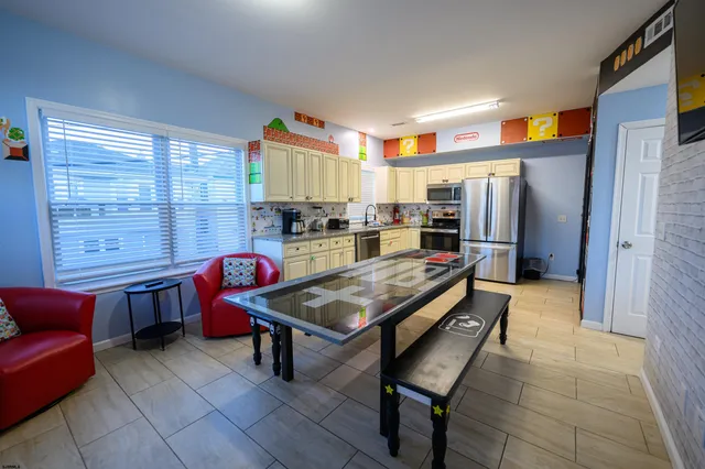 a kitchen with stainless steel appliances granite countertop a refrigerator and a stove