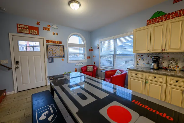 a kitchen with stainless steel appliances granite countertop a stove a sink dishwasher and cabinets with wooden floor