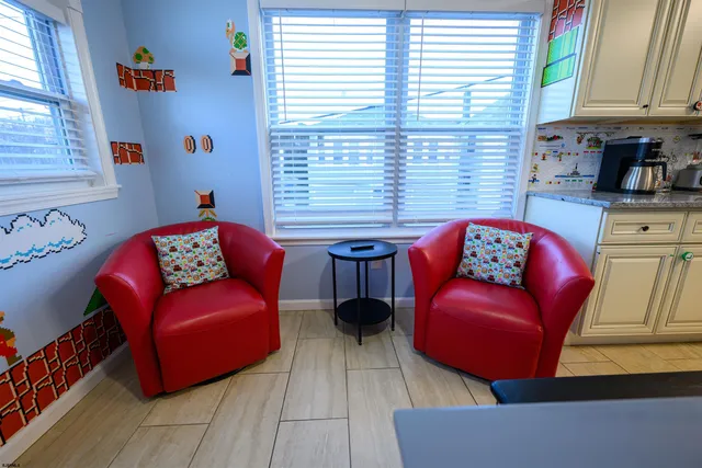 a living room with furniture a large window and a wooden floor