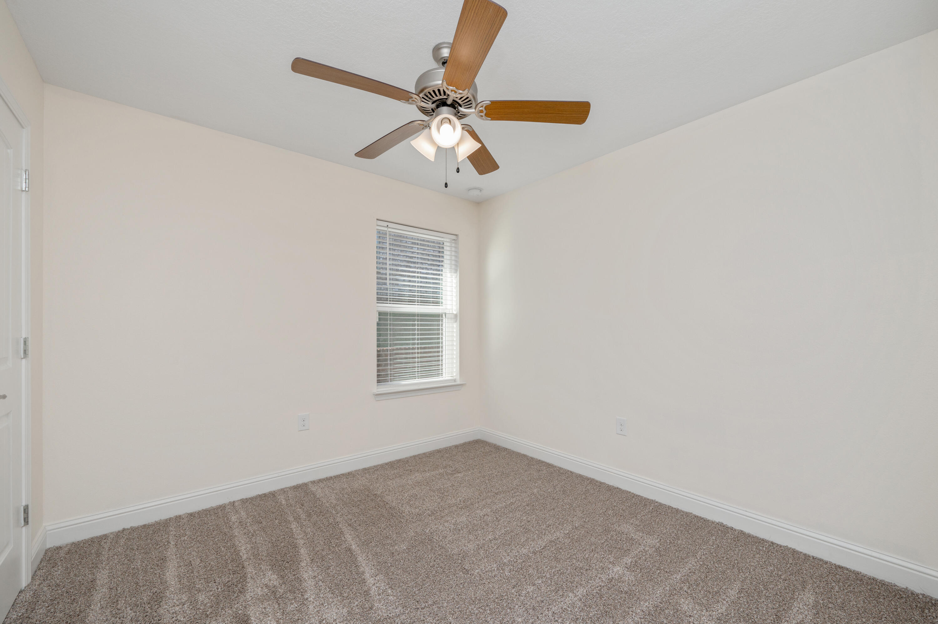 5662 North Brook Drive Crestview, FL 32539 - Photo 16 of 25 an empty room with windows and fan