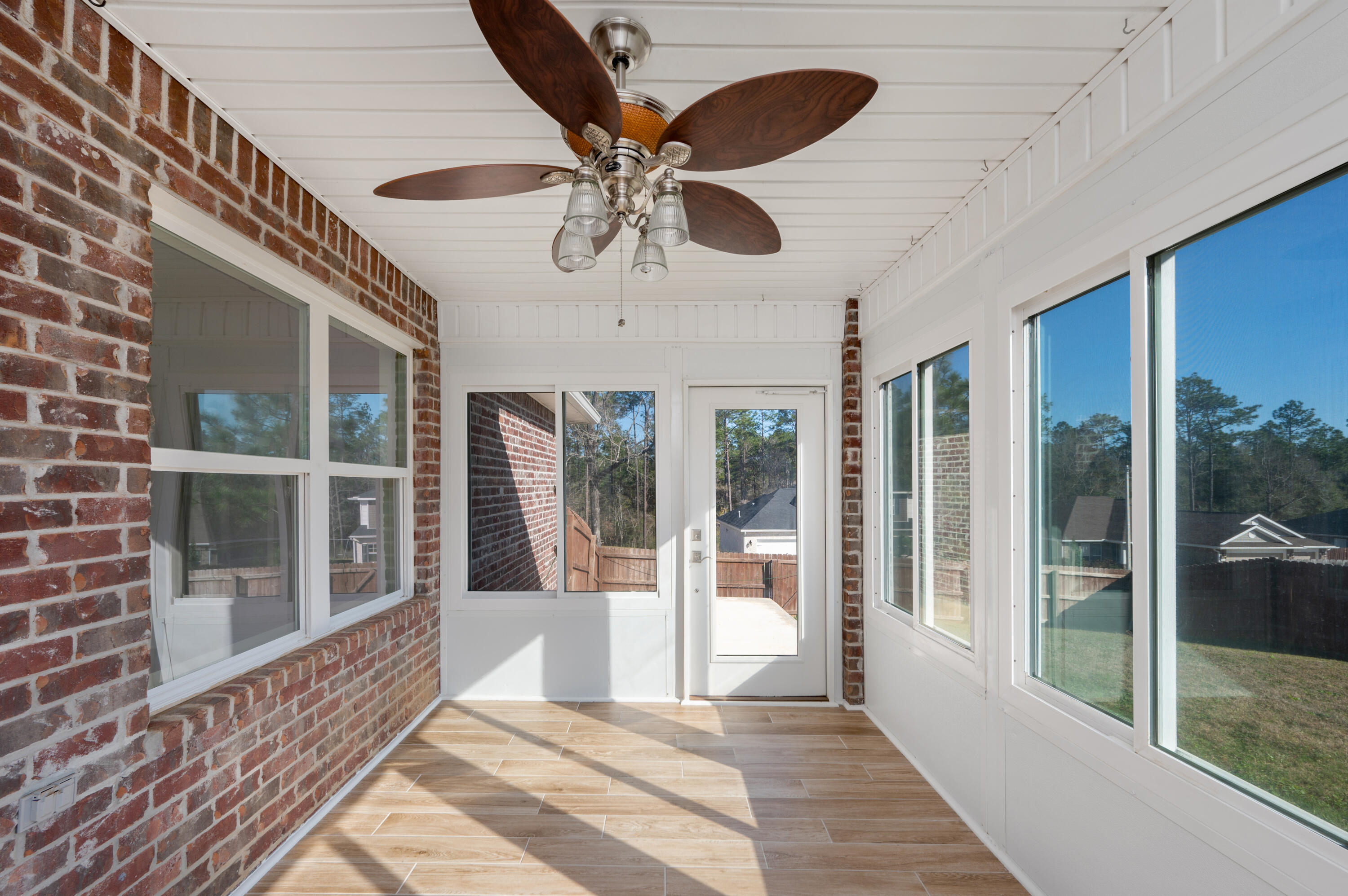 5662 North Brook Drive Crestview, FL 32539 - Photo 20 of 25 a view of a porch with a table and chairs