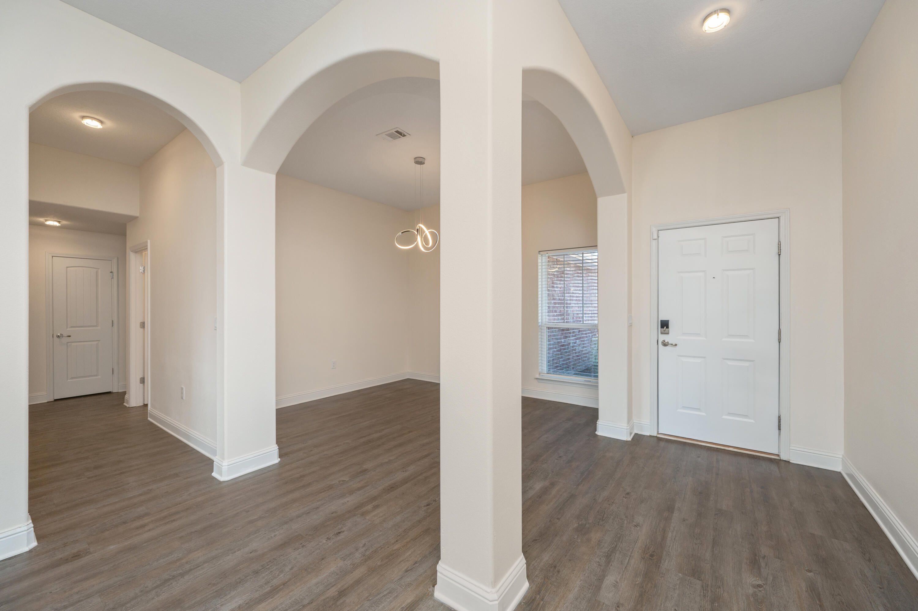 5662 North Brook Drive Crestview, FL 32539 - Photo 2 of 25 a view of an empty room with wooden floor and a bathroom