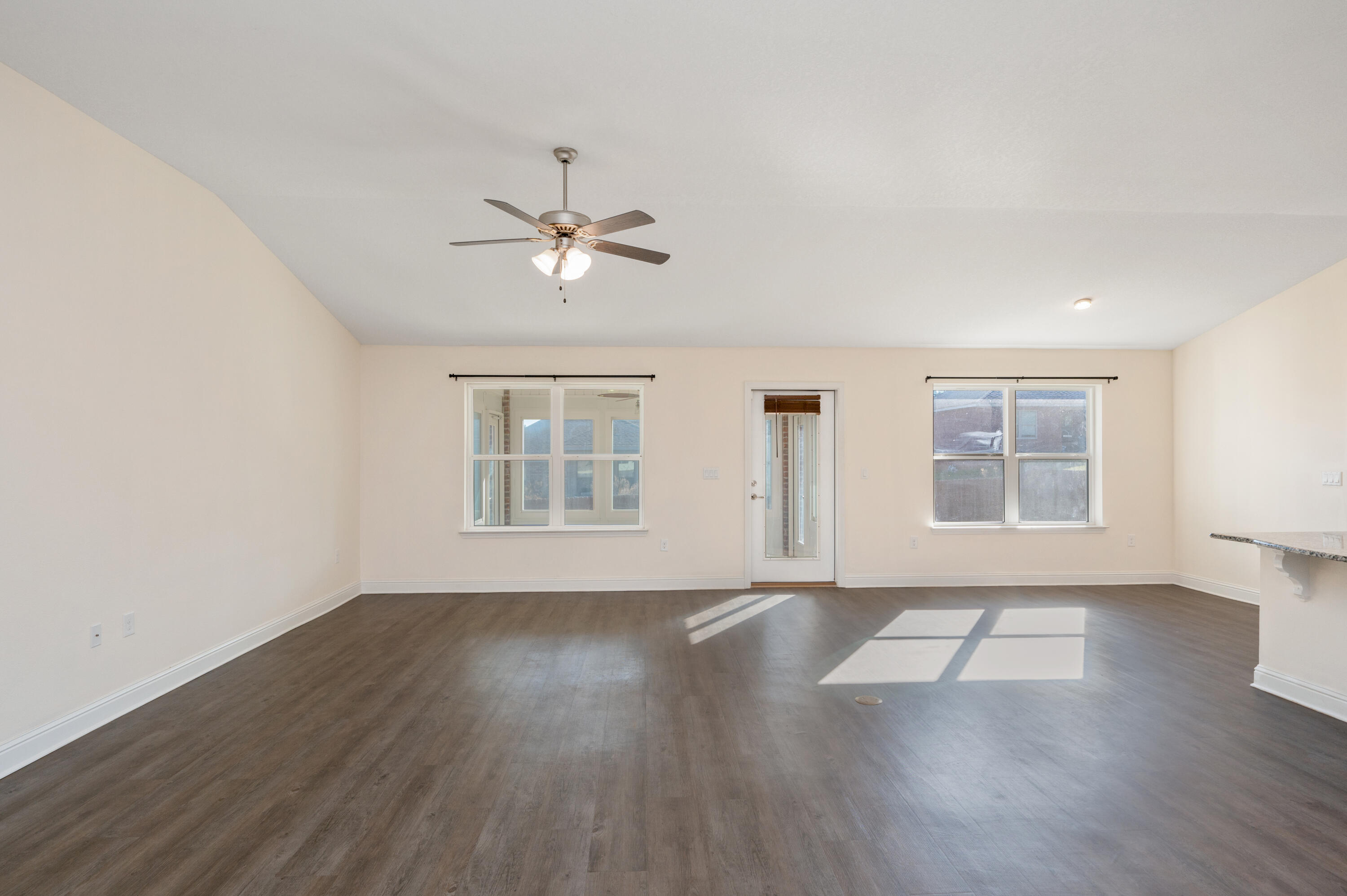 5662 North Brook Drive Crestview, FL 32539 - Photo 3 of 25 a view of an empty room with a window and wooden floor