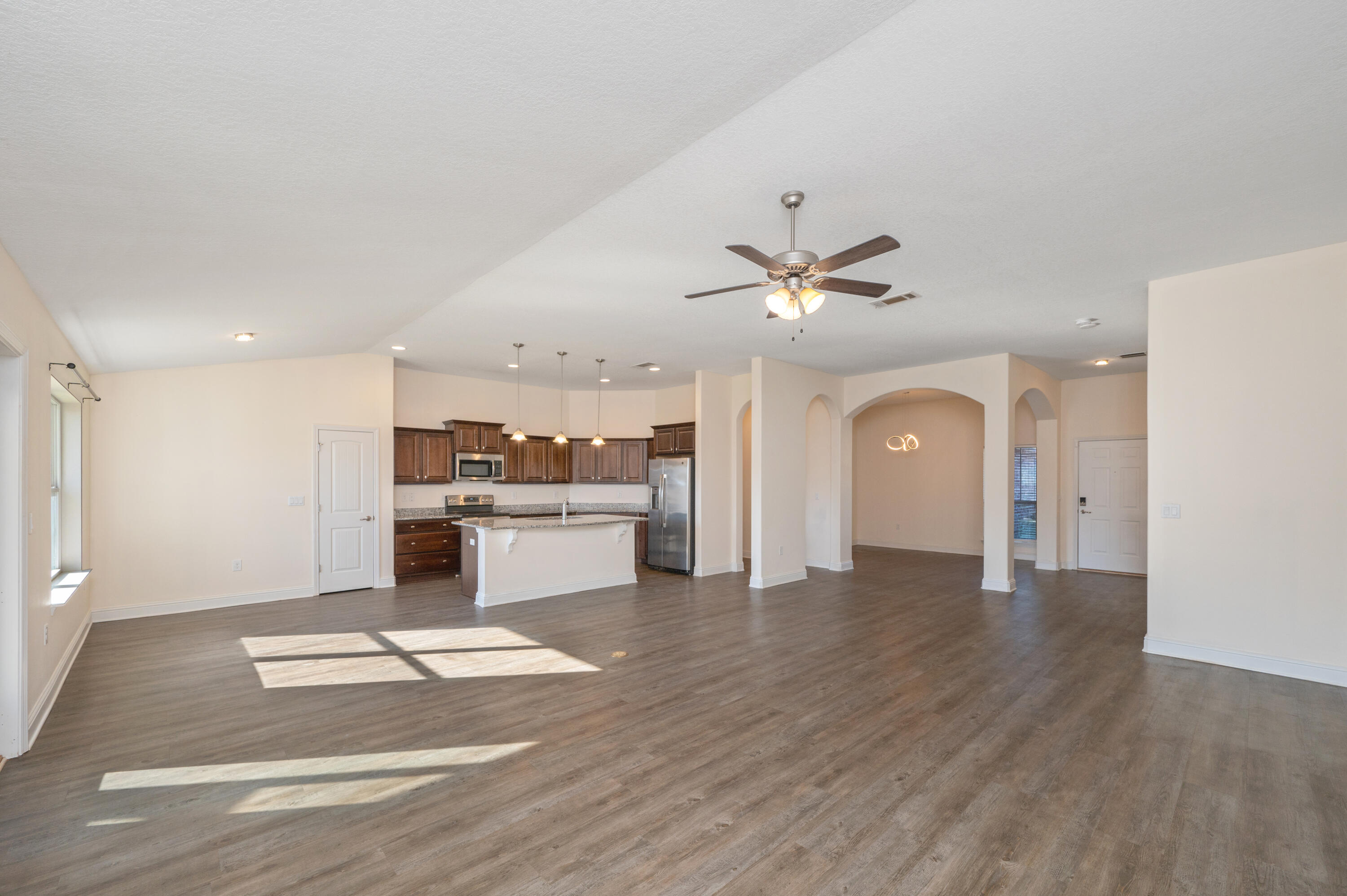 5662 North Brook Drive Crestview, FL 32539 - Photo 4 of 25 a view of a kitchen with a sink hardwood floor and a ceiling fan