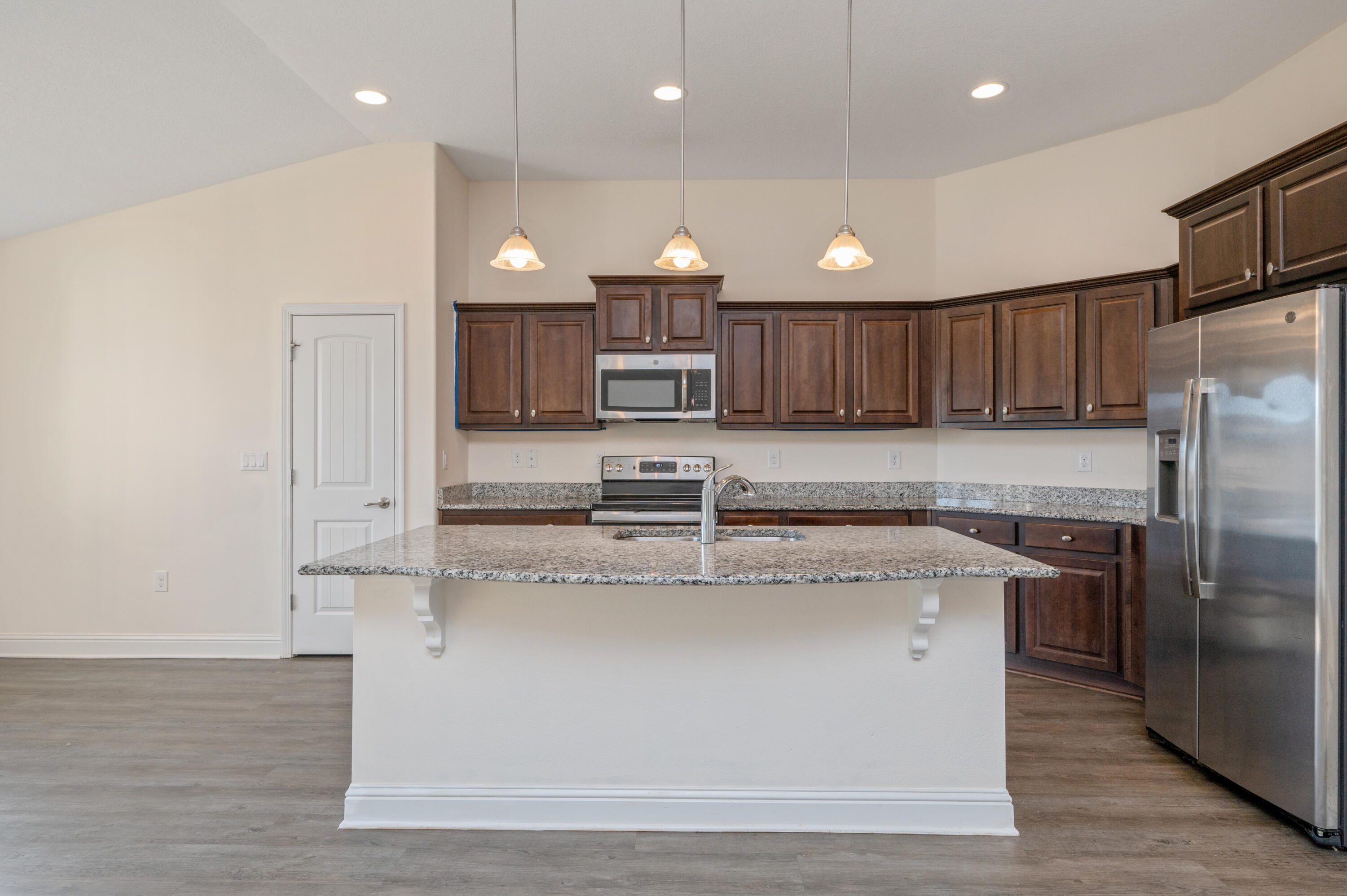 5662 North Brook Drive Crestview, FL 32539 - Photo 6 of 25 a large kitchen with stainless steel appliances granite countertop a sink a oven and a refrigerator