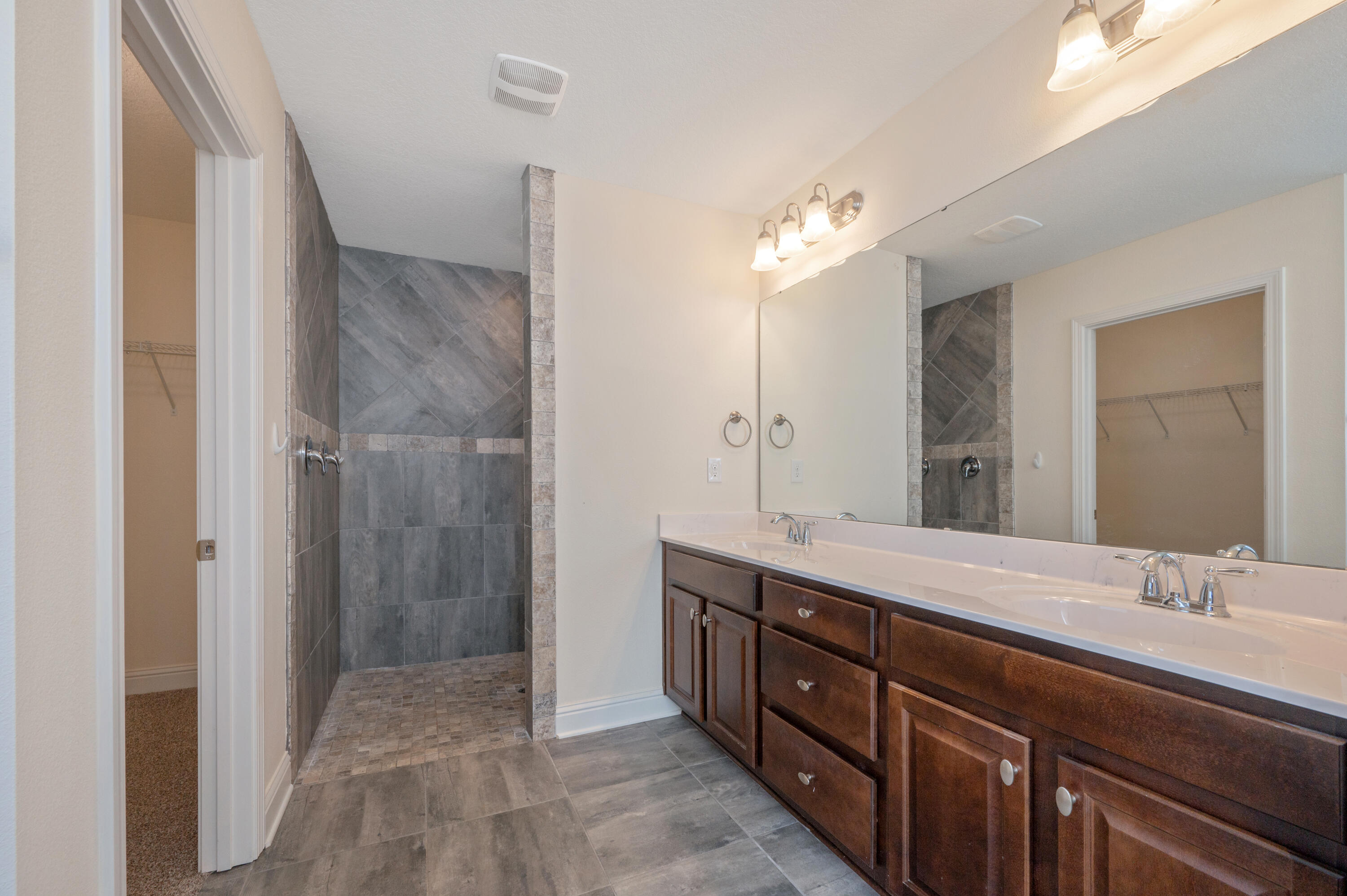 5662 North Brook Drive Crestview, FL 32539 - Photo 9 of 25 a spacious bathroom with a double vanity sink mirror and shower