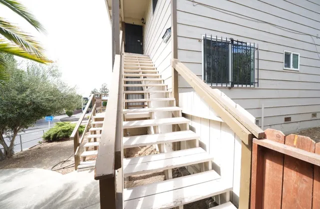a view of balcony with wooden floor and fence