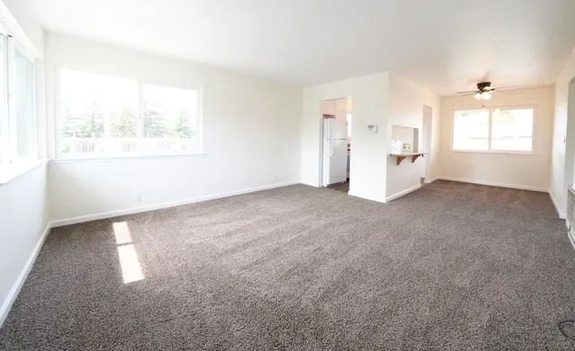 an empty room with windows and closet