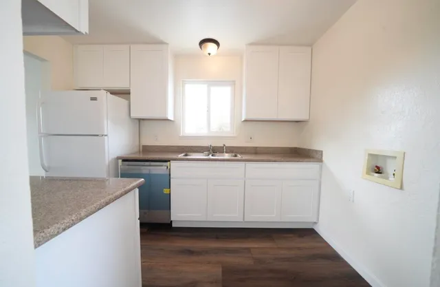 a kitchen with a sink a stove and cabinets