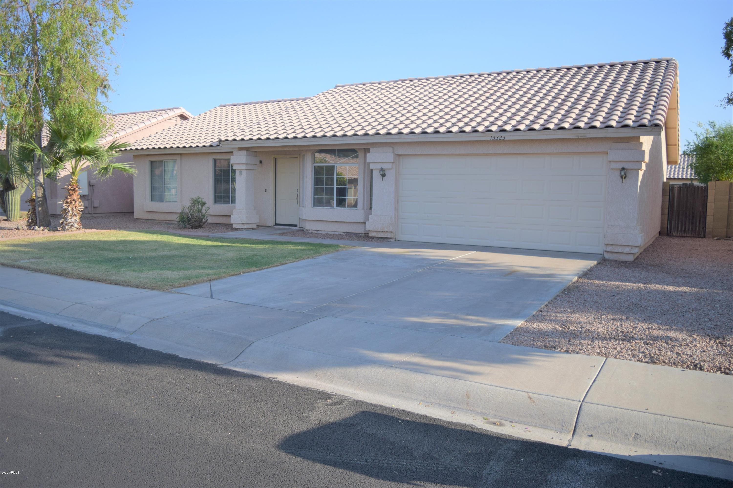 13323 East Butler Street Chandler, AZ 85225 - Photo 2 of 22 a front view of a house with a garden