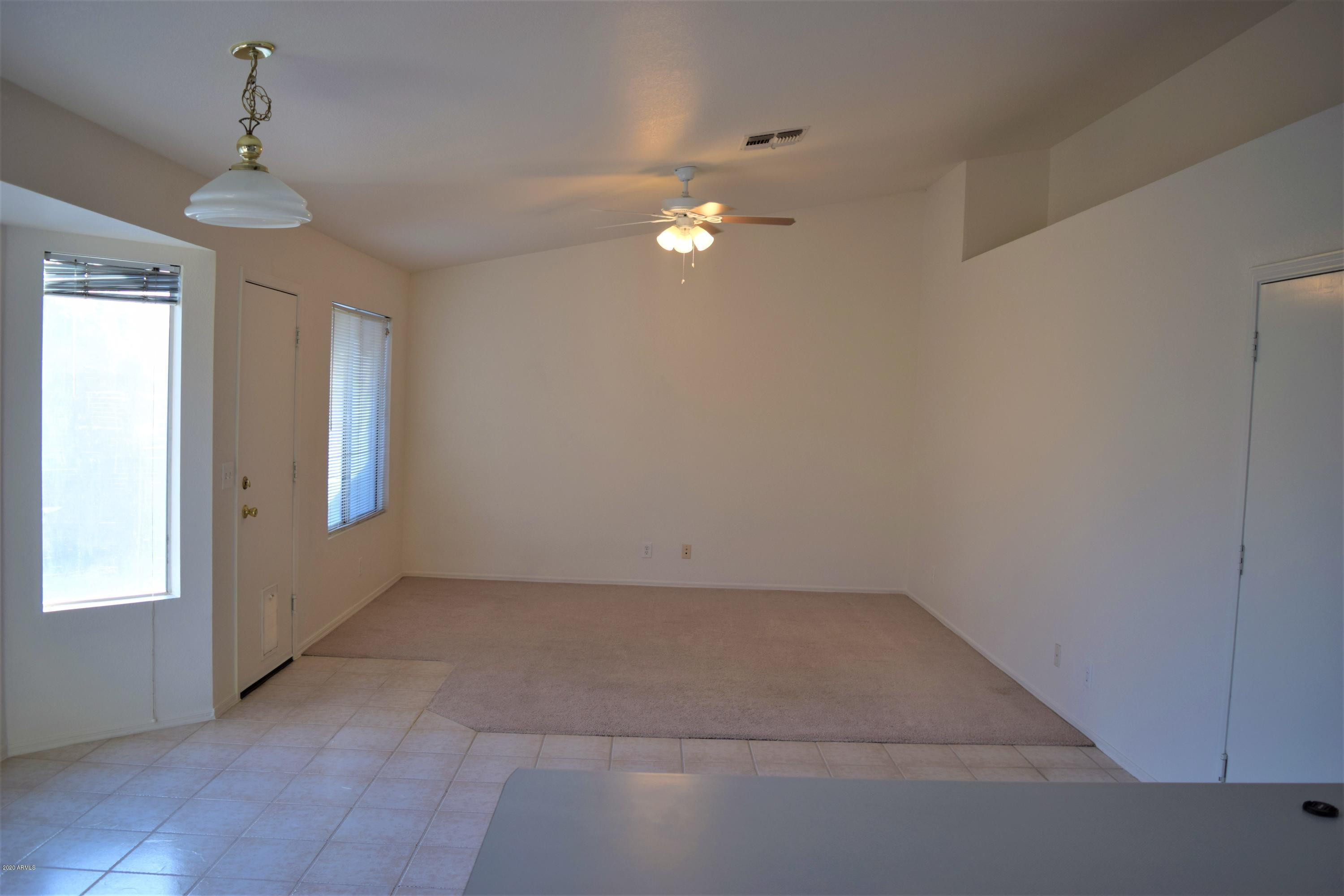 13323 East Butler Street Chandler, AZ 85225 - Photo 4 of 22 en empty room with windows and ceiling fan