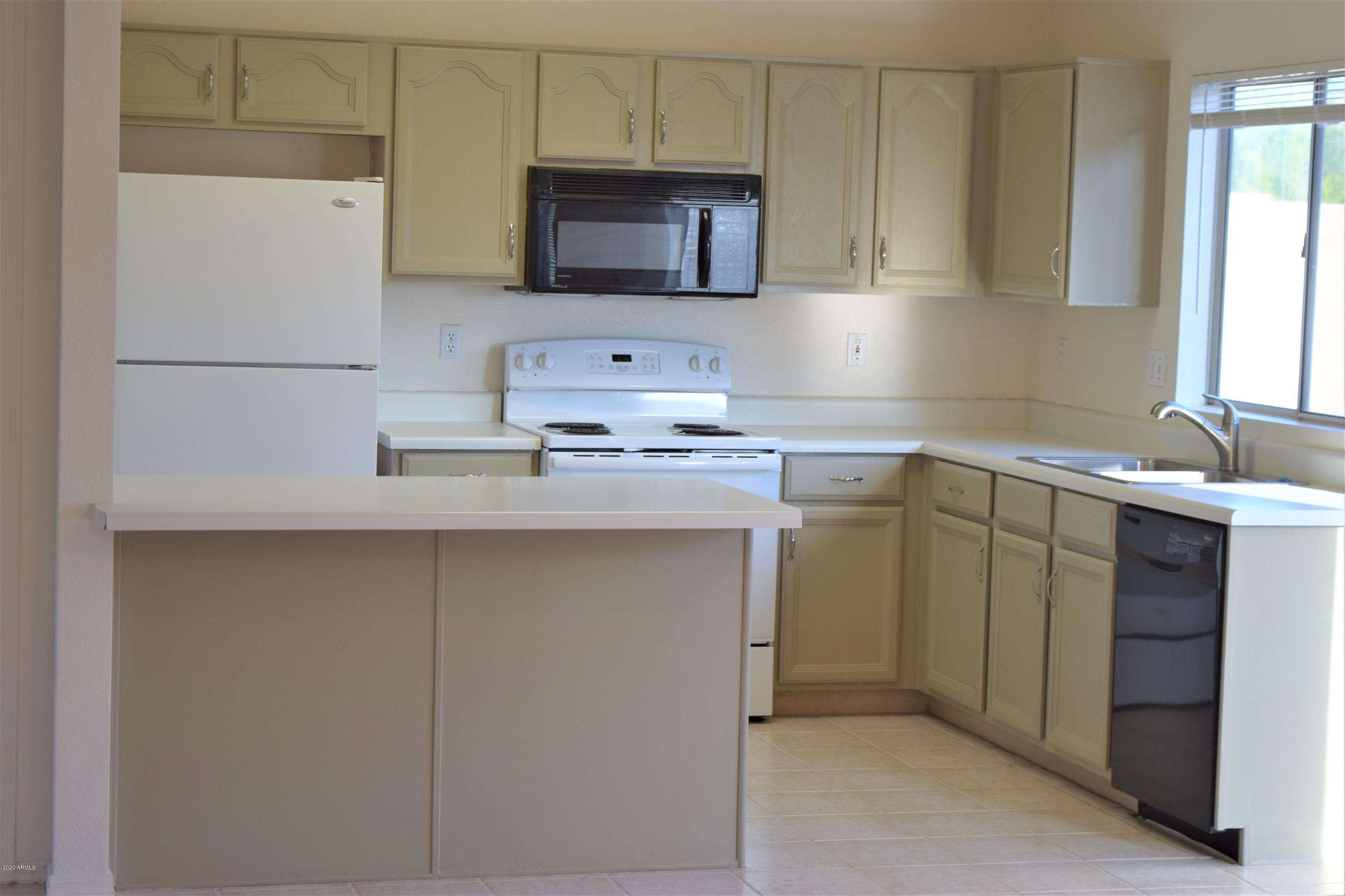 13323 East Butler Street Chandler, AZ 85225 - Photo 6 of 22 a kitchen with stainless steel appliances granite countertop a sink stove and microwave