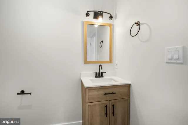 a bathroom with a sink and mirror