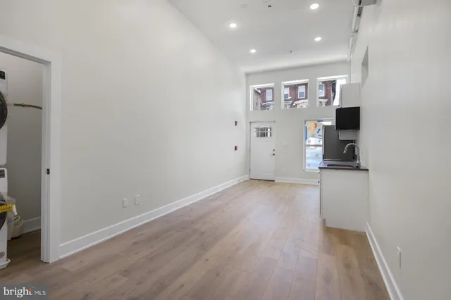 an empty room with wooden floor and closet