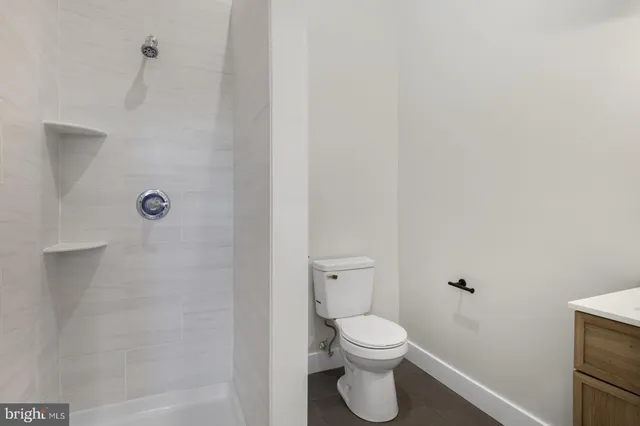 a bathroom with a toilet and a shower