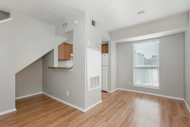 a view of kitchen with wooden floor electronic appliances and window