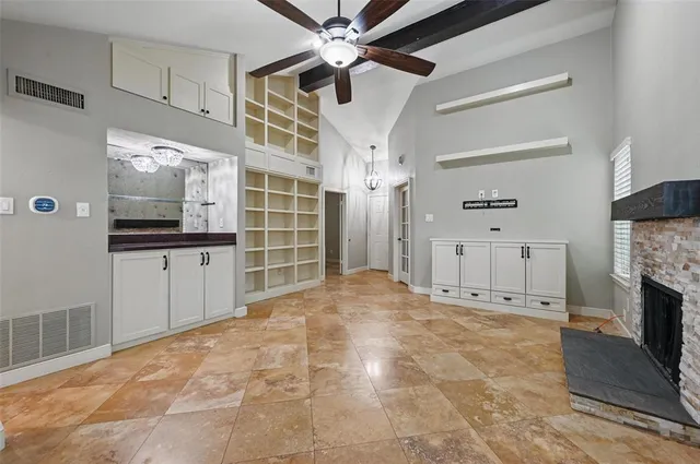 a view of a livingroom with an empty space and a kitchen