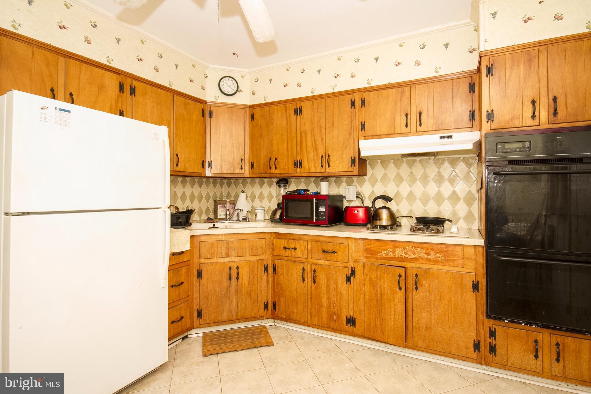 118 Byway Road Owings Mills, MD 21117 - Photo 11 of 25 a kitchen with stainless steel appliances a refrigerator and a stove