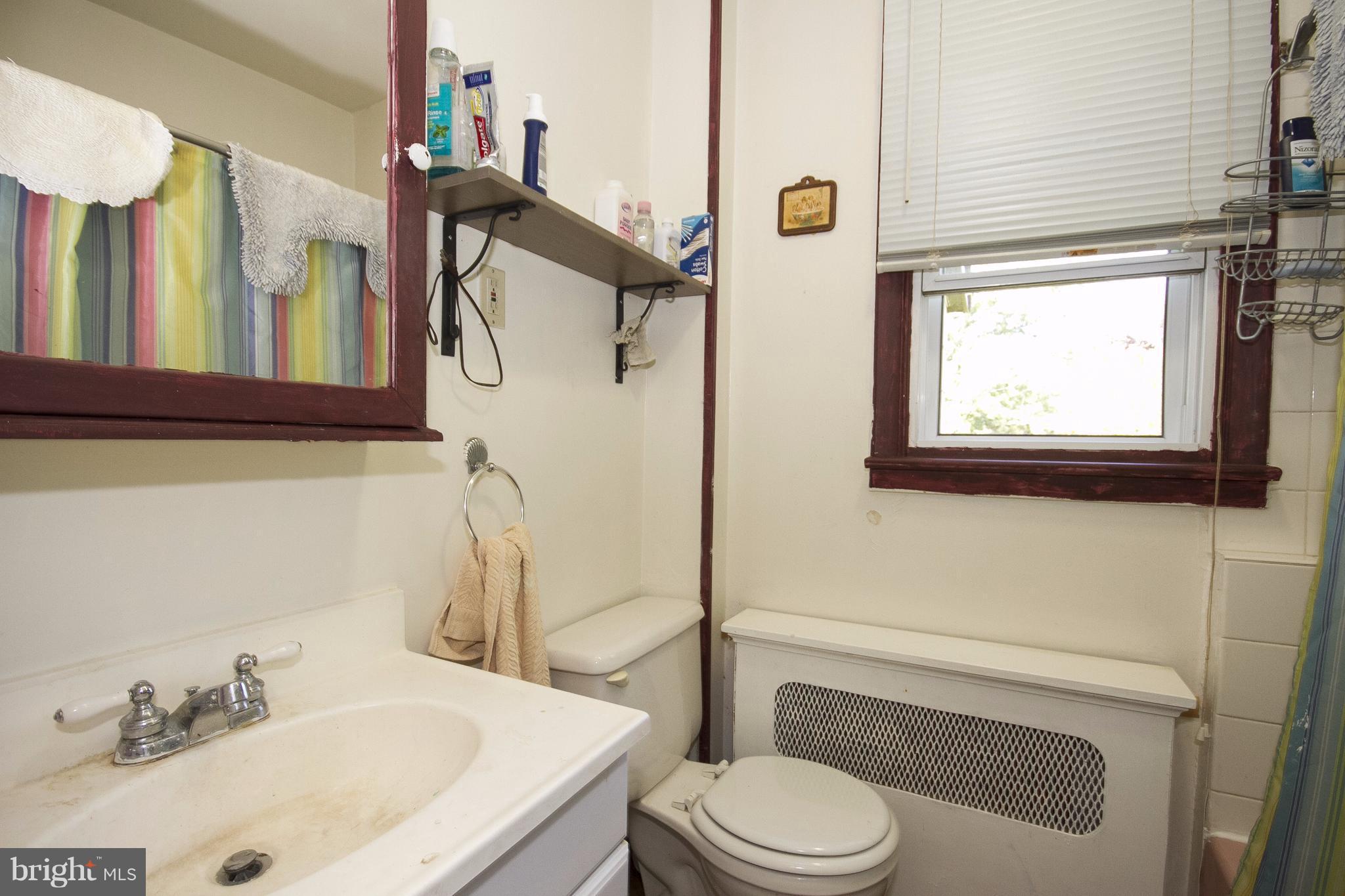 118 Byway Road Owings Mills, MD 21117 - Photo 16 of 25 a bathroom with a sink a toilet and a mirror