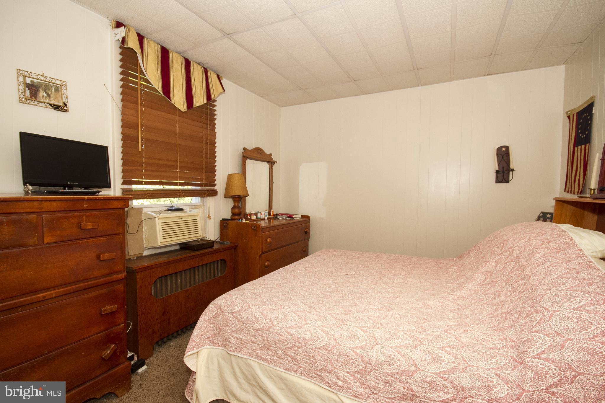 118 Byway Road Owings Mills, MD 21117 - Photo 18 of 25 a bedroom with a bed and flat screen tv
