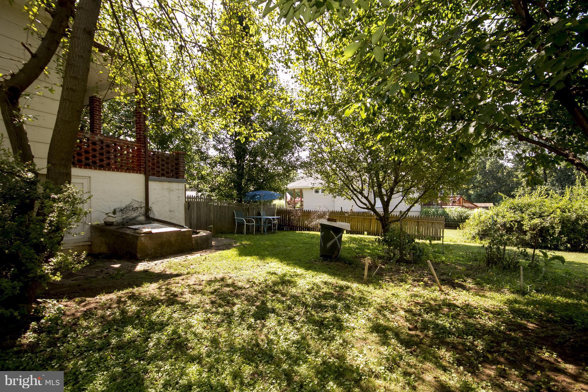 118 Byway Road Owings Mills, MD 21117 - Photo 25 of 25 a view of a backyard with table and chairs and a fire pit