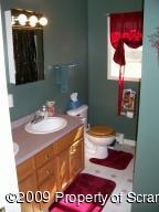 1765 Howe Road Moscow, PA 18444 - Photo 11 of 21 a bathroom with a toilet sink and mirror
