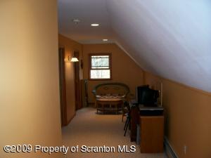 1765 Howe Road Moscow, PA 18444 - Photo 14 of 21 a view of a hallway to room with wooden floor and windows