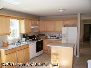 1765 Howe Road Moscow, PA 18444 - Photo 6 of 21 a kitchen with a sink a stove a refrigerator and cabinets