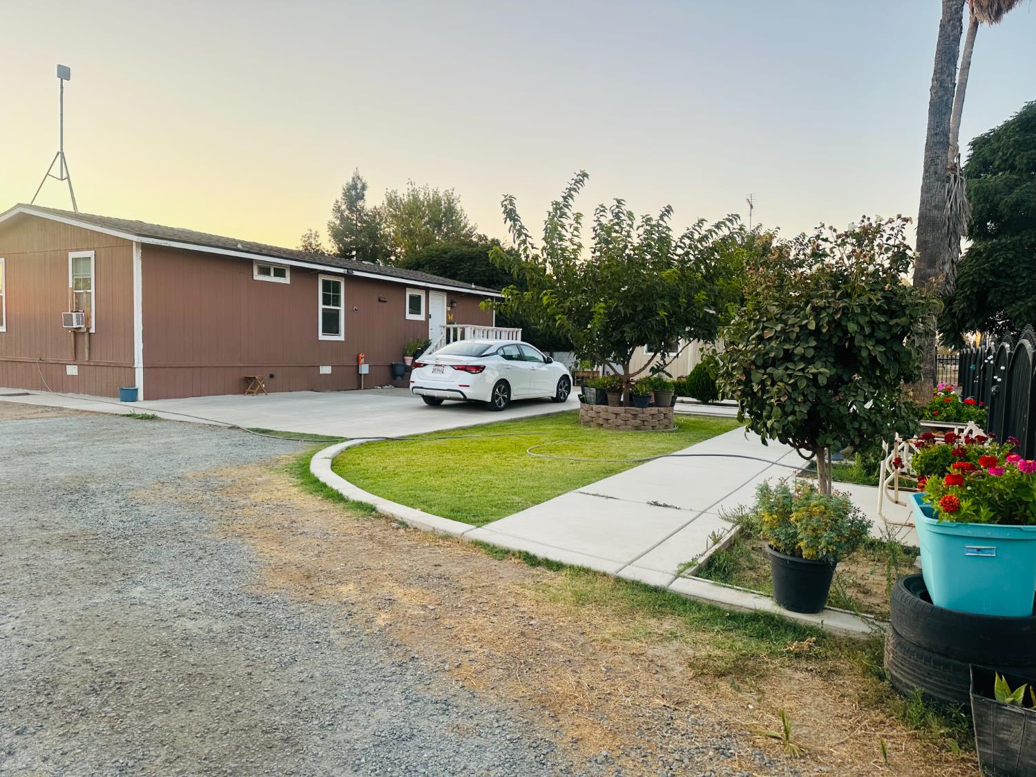 22788 Maple Street Chowchilla, CA 93610 - Photo 5 of 20 a view of a house with backyard and sitting area