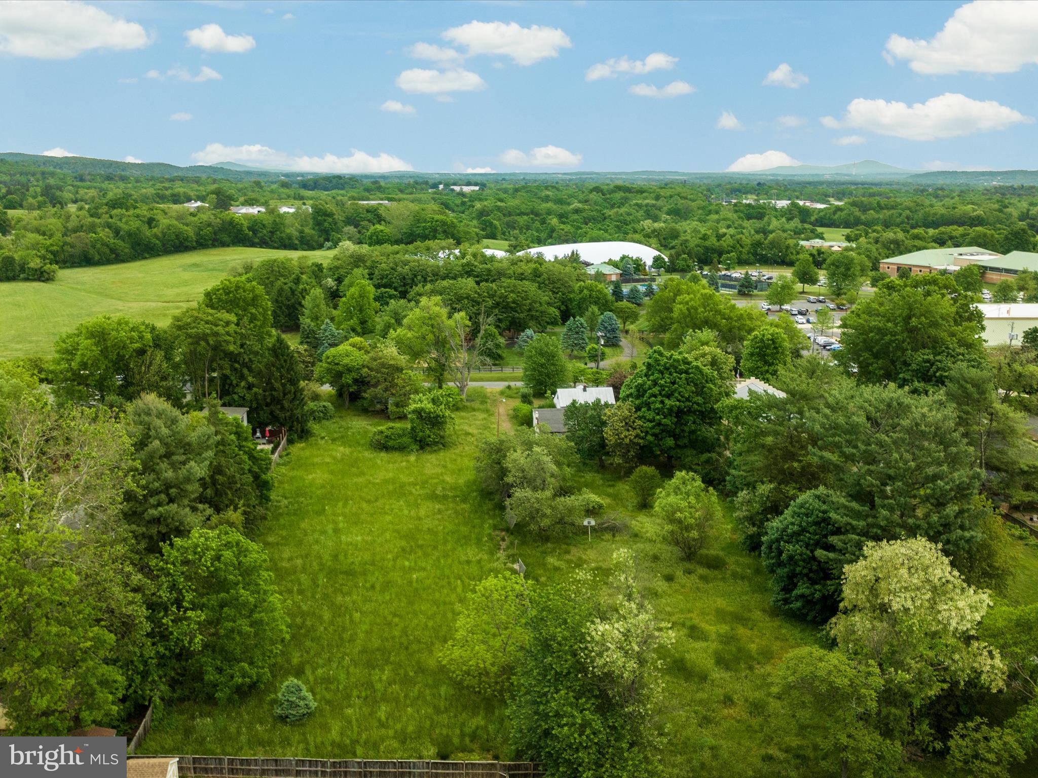 405 Old Waterford Road Northwest Leesburg, VA 20176 - Photo 4 of 14 a view of a green field with lots of trees