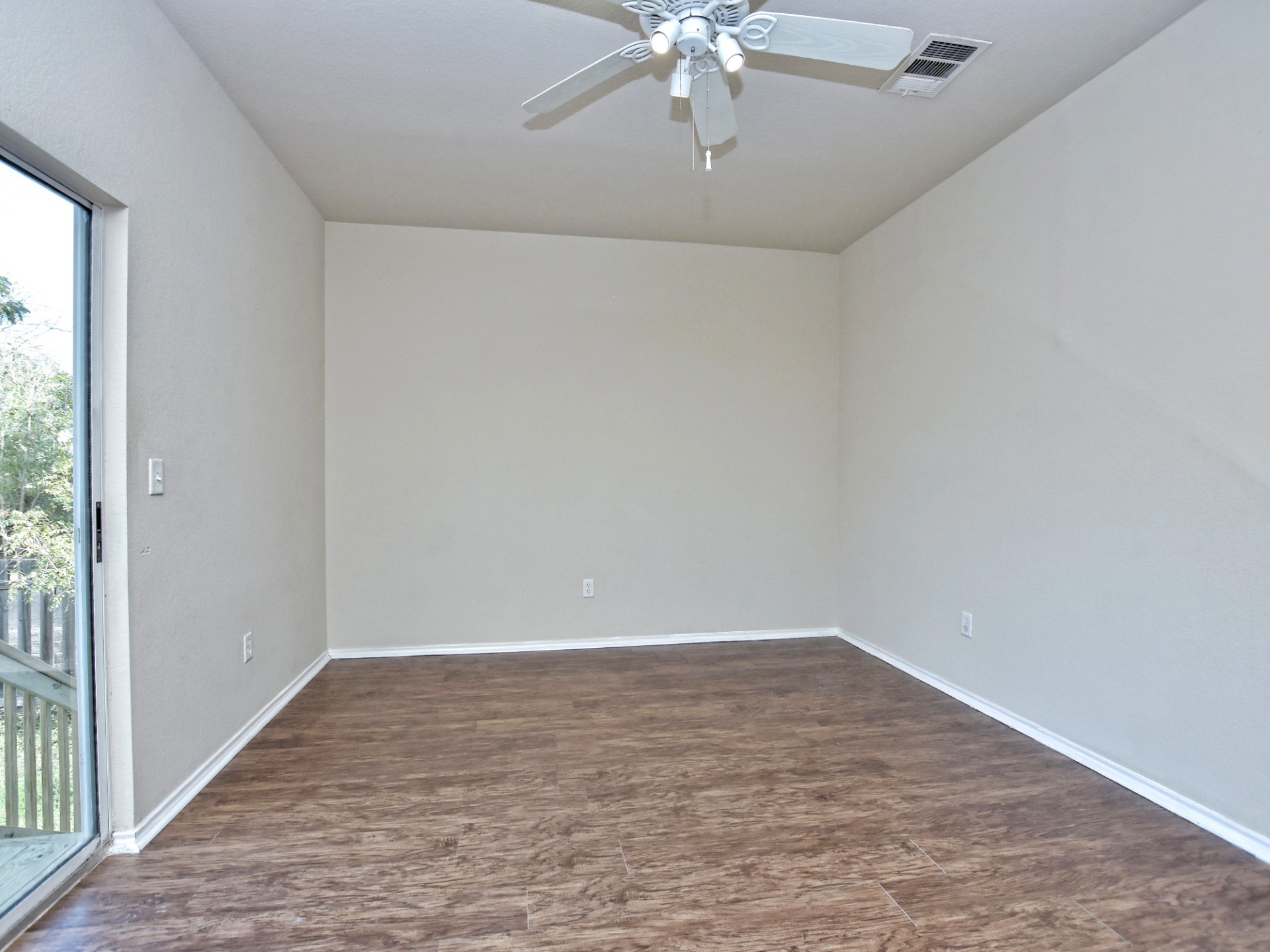 917 East 3rd Street Georgetown, TX 78626 - Photo 12 of 23 A versatile interior space featuring durable laminate flooring and direct outdoor access.