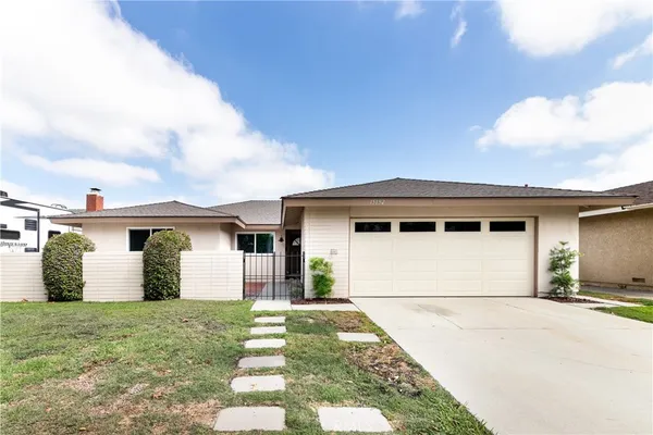 a view of a house with a yard and garage
