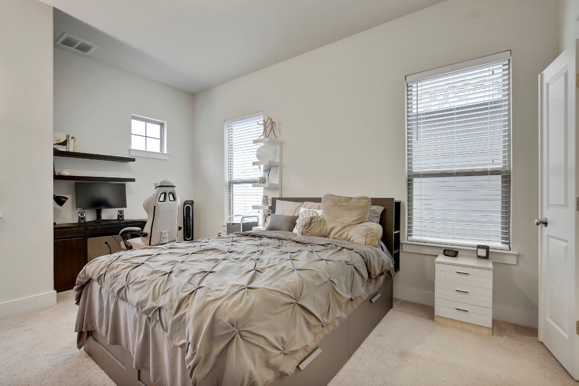 13001 Hymeadow Drive, Unit 39 Austin, TX 78729 - Photo 18 of 39 a bedroom with a bed and a window