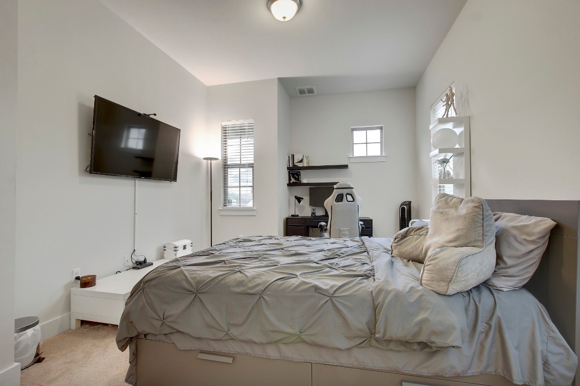 13001 Hymeadow Drive, Unit 39 Austin, TX 78729 - Photo 19 of 39 a bedroom with a bed and a flat screen tv