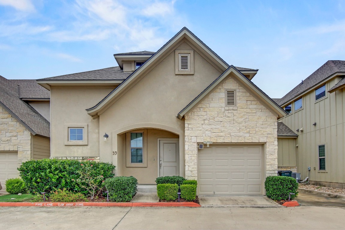 13001 Hymeadow Drive, Unit 39 Austin, TX 78729 - Photo 2 of 39 a front view of a house with a yard