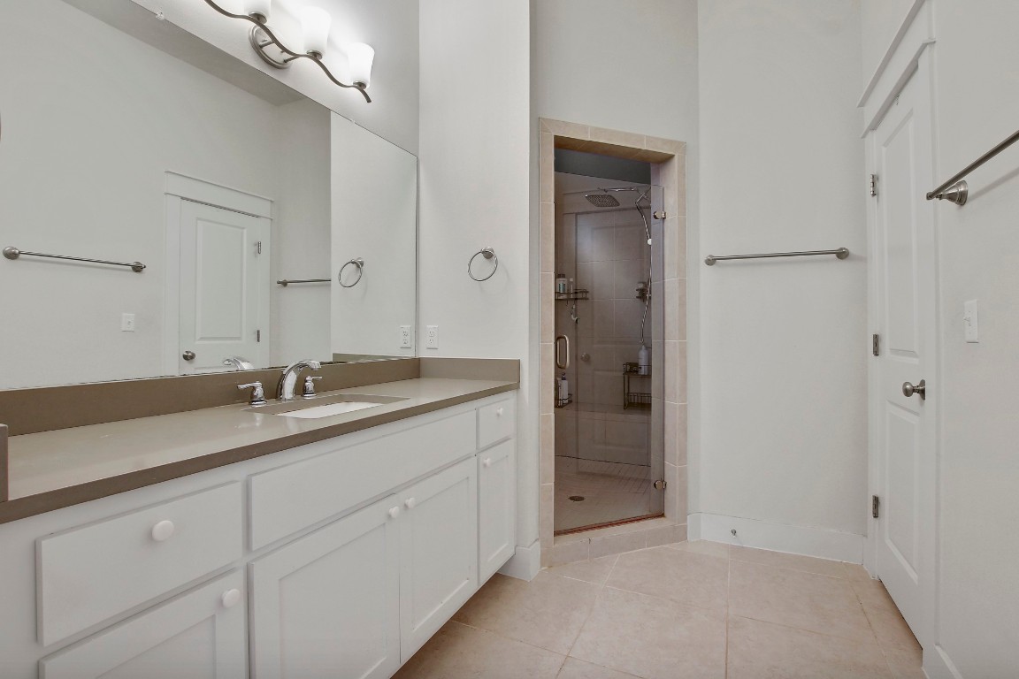 13001 Hymeadow Drive, Unit 39 Austin, TX 78729 - Photo 21 of 39 a bathroom with a double vanity sink and mirror