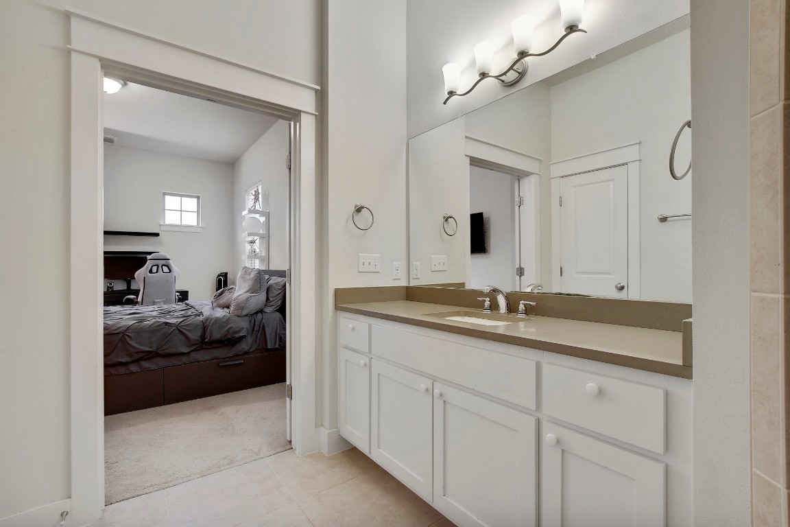 13001 Hymeadow Drive, Unit 39 Austin, TX 78729 - Photo 23 of 39 a en suite bathroom with double sink and a mirror