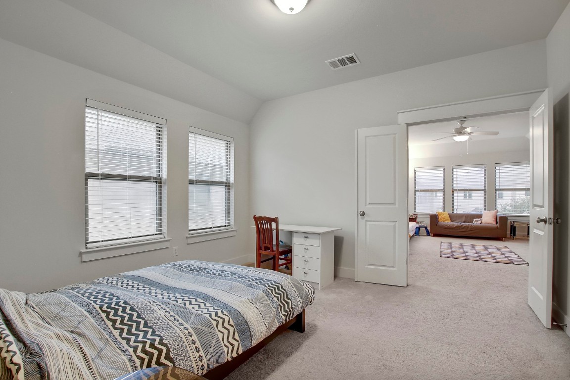 13001 Hymeadow Drive, Unit 39 Austin, TX 78729 - Photo 29 of 39 a spacious bedroom with a bed and a couch
