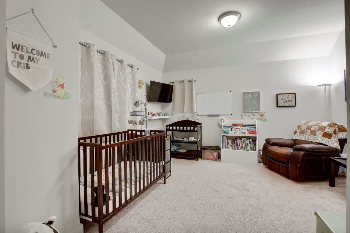 13001 Hymeadow Drive, Unit 39 Austin, TX 78729 - Photo 30 of 39 a bedroom with furniture and a flat screen tv