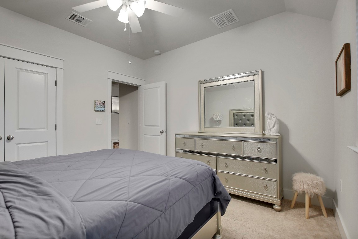 13001 Hymeadow Drive, Unit 39 Austin, TX 78729 - Photo 35 of 39 a bedroom with a bed and a chandelier