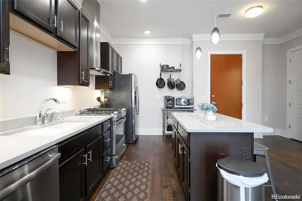 708 13th Street, Unit 250 Golden, CO 80401 - Photo 2 of 27 a kitchen with a sink stainless steel appliances and cabinets