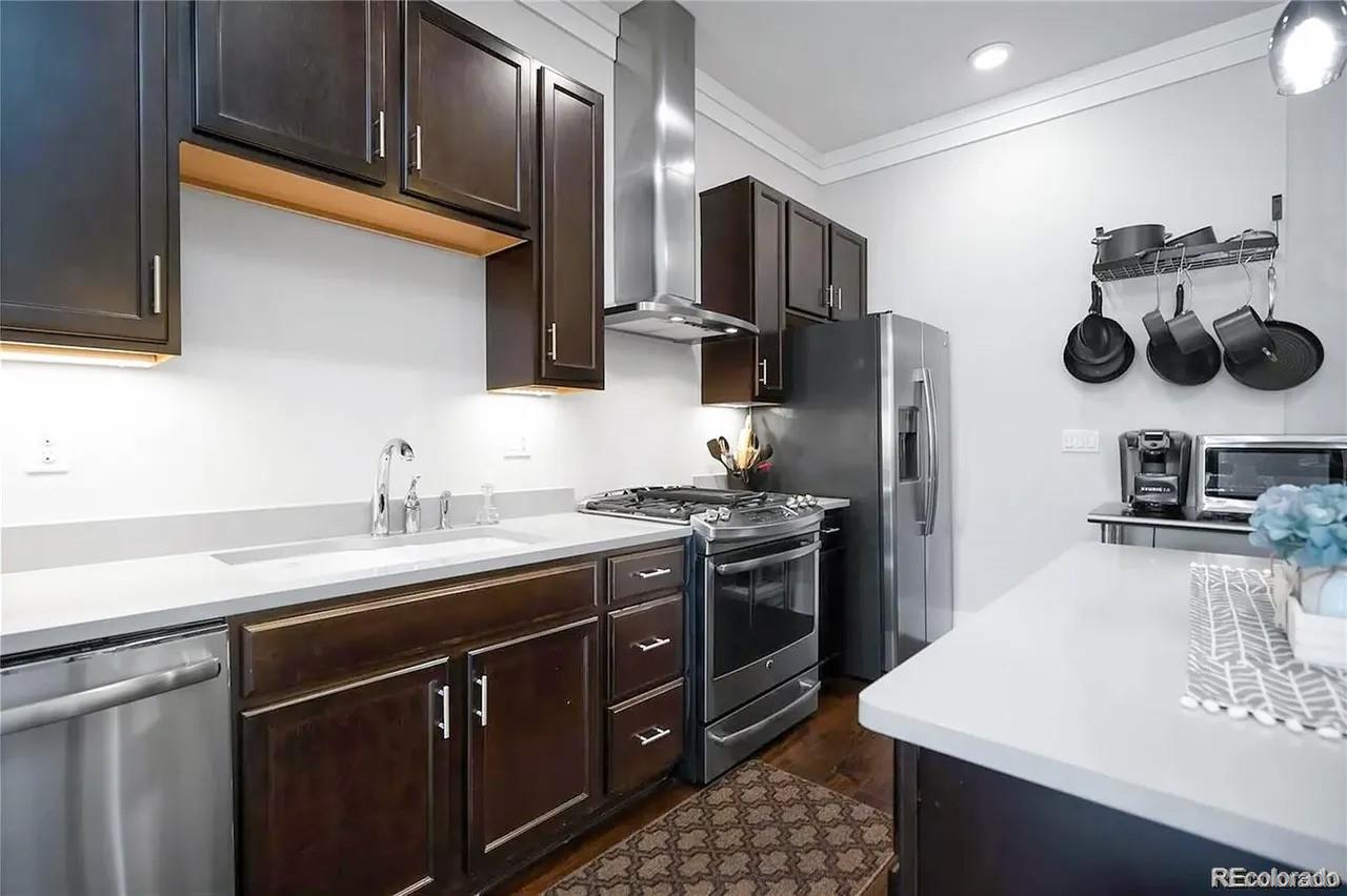 708 13th Street, Unit 250 Golden, CO 80401 - Photo 3 of 27 a kitchen with a sink a stove and cabinets
