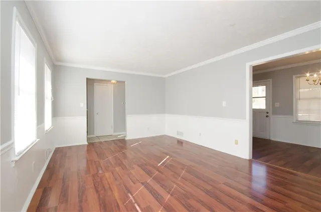 wooden floor in an empty room with a window