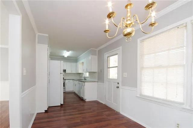 a view of a kitchen with a dishwasher cabinets and wooden floor