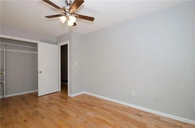 an empty room with windows and closet