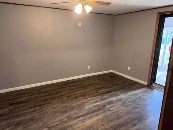 a view of a room with wooden floor