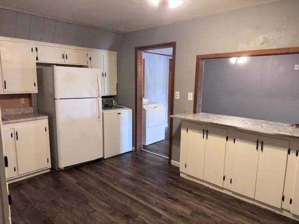 a white refrigerator freezer sitting inside of a kitchen