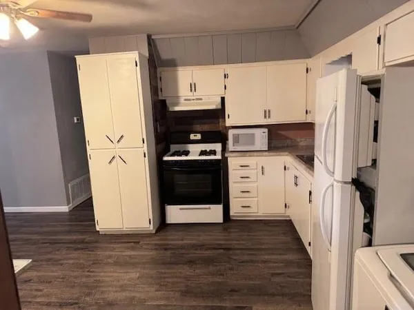 a kitchen with stainless steel appliances a refrigerator sink and cabinets