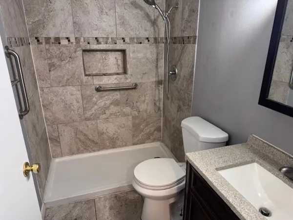 a bathroom with a sink toilet and shower