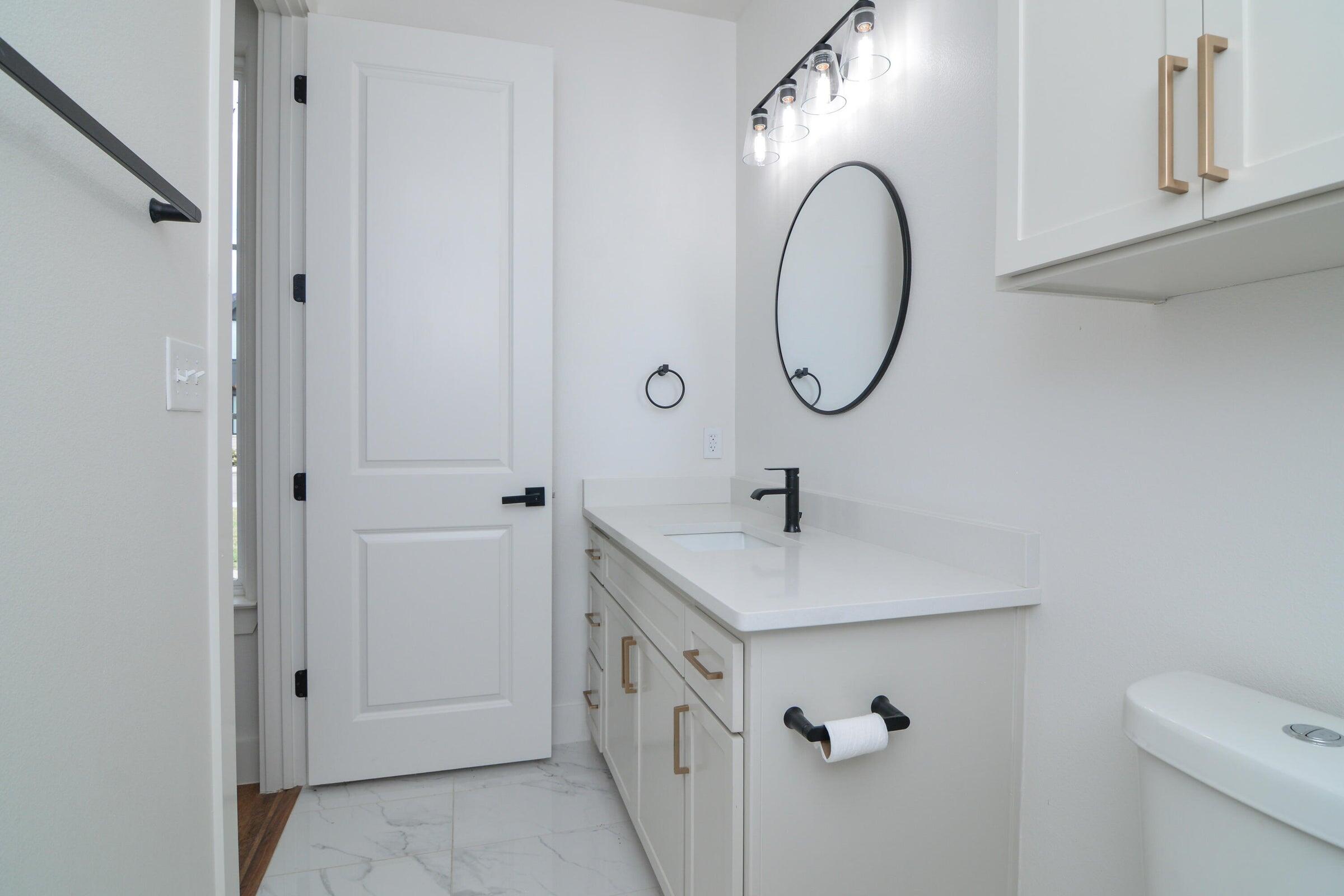 7801 56th Street Lubbock, TX 79407 - Photo 20 of 29 a bathroom with a double vanity sink and a mirror